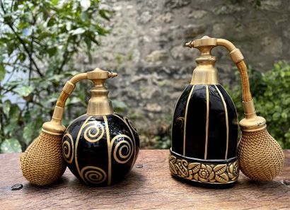 null Two perfume bottles in black tinted glass and painted with gold with floral...