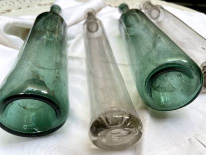 null Four glass bottles, one pair colored blue-green.

Late 18th century

H. of one...