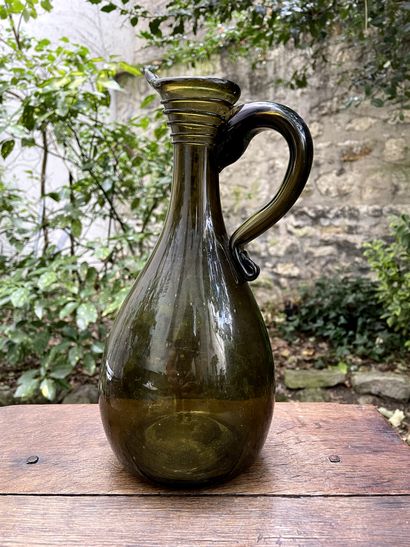 Green-ambered glass pitcher 
France, late...
