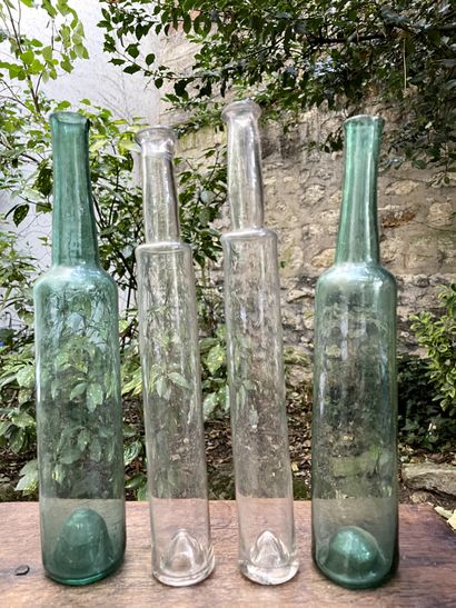 Four glass bottles, one pair colored blue-green....