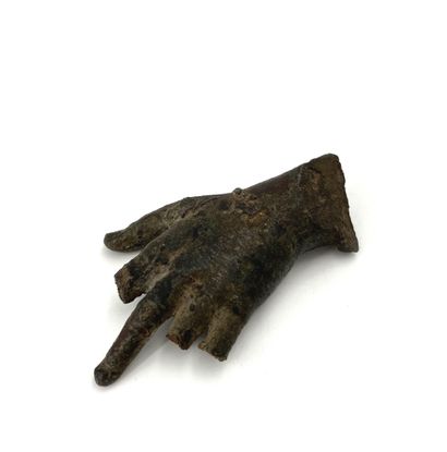 Bronze hand, of which only the middle finger...