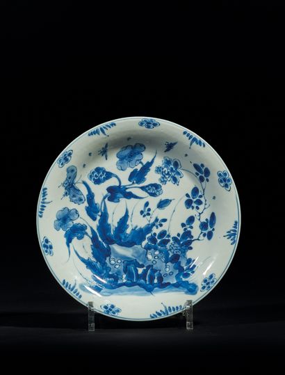 CHINE - EPOQUE KANGXI (1662 - 1722) 瓷盘，釉下青花装饰有穿孔岩石、牡丹和蝴蝶（划痕，碎片）
直径21,1厘米