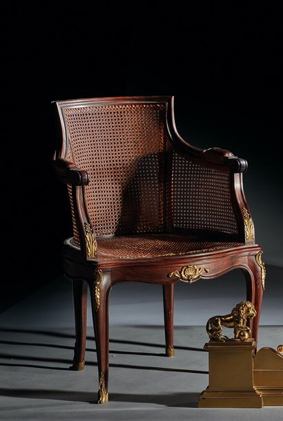 null Mahogany desk chair with cane base decorated with chased and gilded foliage...