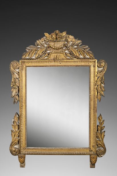 Mirror in carved and gilded wood and partially...