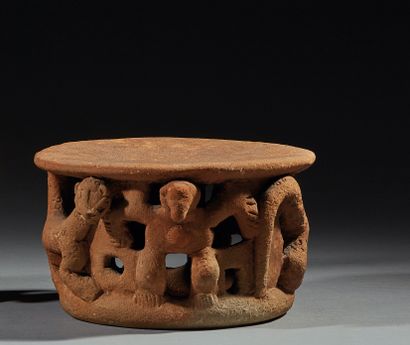Circular ochre terracotta votive seat decorated...