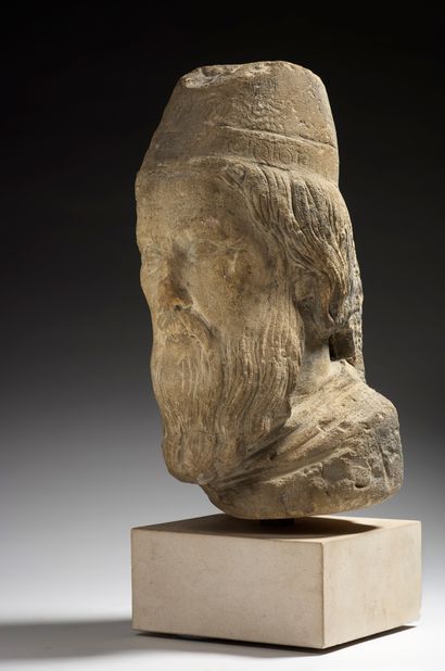 null 
Head of a king or high priest in sculpted limestone with traces of gray paint....