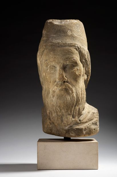 null 
Head of a king or high priest in sculpted limestone with traces of gray paint....