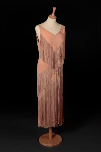 Marcelle Dormoy Evening dress in apricot silk crepe. Straight shape, barely flared,...