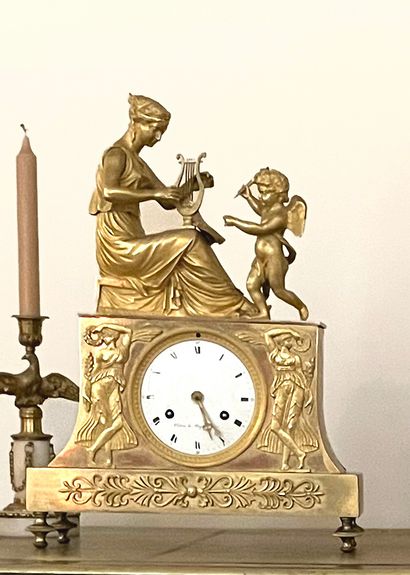 null Gilt bronze clock decorated with the allegory of Music, a woman playing the...