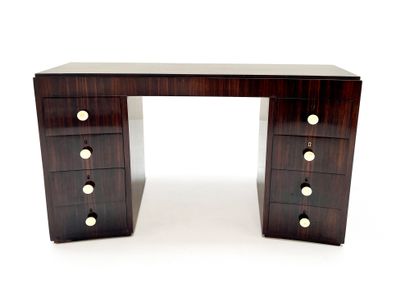 JACQUES ADNET (1900-1984) 
Rosewood veneer desk with curved molded top resting on...