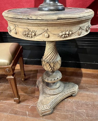 null Pedestal table in natural wood with rich carved and molded decoration of garlands...