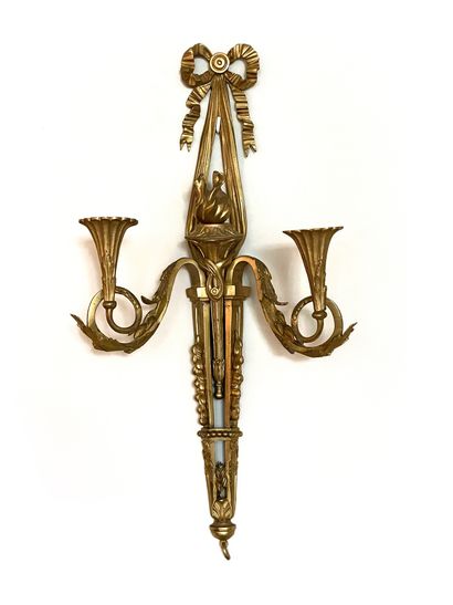 null Pair of sconces in molded, carved and gilded bronze with two arms of light decorated...
