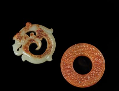 CHINE Two ornaments, one bi in brown agate carved with spirals, the other in round...