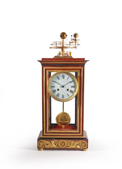 null Gilt brass and polished and blackened mahogany striking clock with calendar...