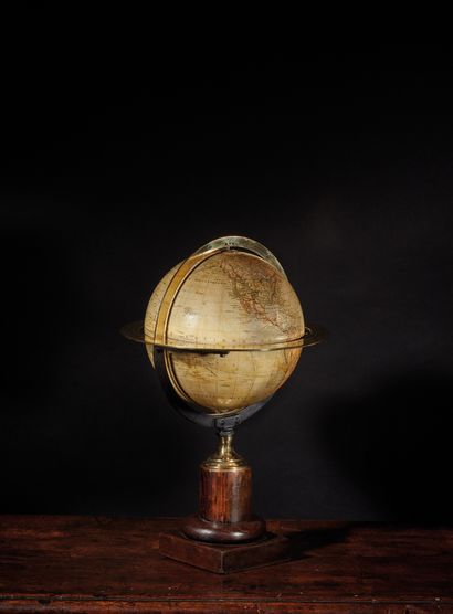 null Earth globe with graduated brass meridian and equatorial circles on a stained...