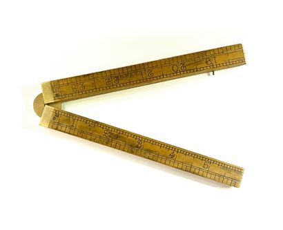 null Wood and brass folding measuring ruler in feet
England 19th century