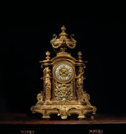 null Clock in chased and gilded bronze with rich decoration. The partially enamelled...