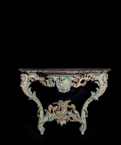 null A console with a carved openwork wood form, relacquered in cream and polychrome,...