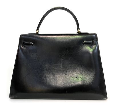 null Hermes Paris. Kelly model handbag in black leather with gold metal trim, lock...