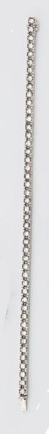 null Line bracelet in 18K (750°/00) white gold paved with emerald-cut diamonds, approx....