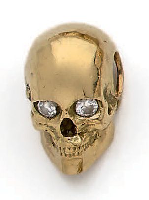 null Pendentif tête de mort en or jaune 18K (750°/00) orné de deux diamants ronds...