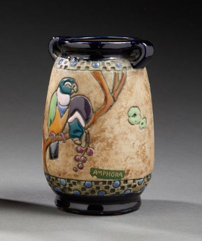 AMPHORA 
Vase en faïence émaillée à décor d'un couple de perroquets branchés dans...