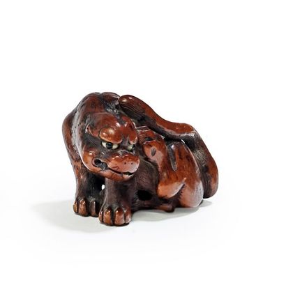 JAPON - XIXE SIÈCLE 
Wooden Netsuke, sitting tiger scratching his ear on his left...