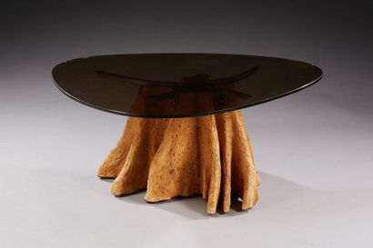TRAVAIL MODERNE 
Table basse à plateau de forme libre en verre fumé reposant sur...