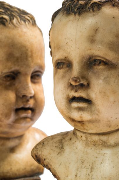  Paire de bustes de putto en marbre, chacun posé sur une base. Les deux enfants ont...