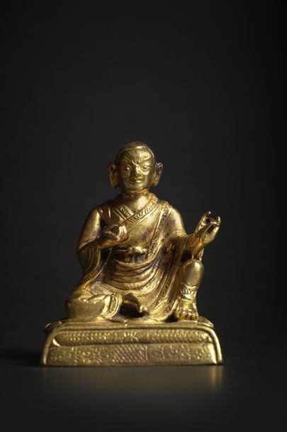 TIBET - XVIIIe siècle Statuette de lhama en bronze doré, assis en lilasana sur un...