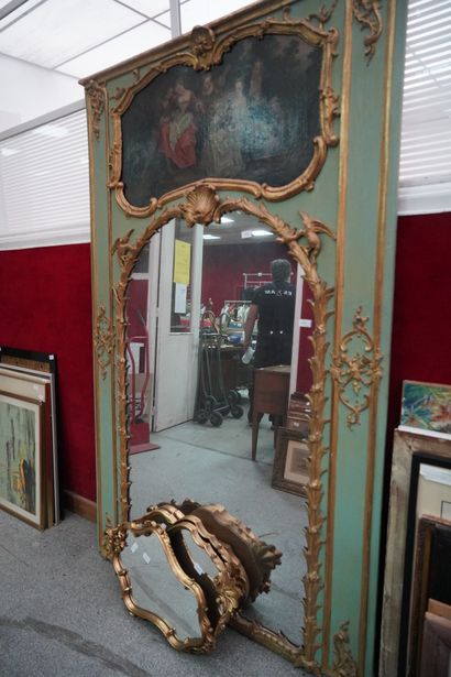 null Trumeau en bois sculpté, relaqué vert et doré, le miroir cintré à décor de feuillages...