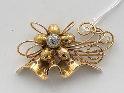 null 18K (750 thousandths) yellow gold brooch in the shape of a flower, and scrolls....