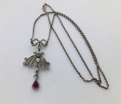 null White gold necklace, holding a falling pendant decorated with small roses and...