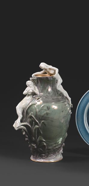 PROFESSEUR JOSEPH VETTER, PORCELAINE DE KRONACH 罕见的浮雕花瓶 瓷器上有五彩釉，绿色背景上有植物装饰，浮雕上有一个牧羊人用他的风笛吸引着一个爬上脖子的仙女。
，瓶身上有签名...