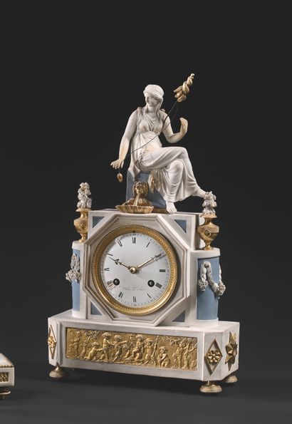 null A blue and white biscuit and ormolu clock, the circular enamelled dial with...