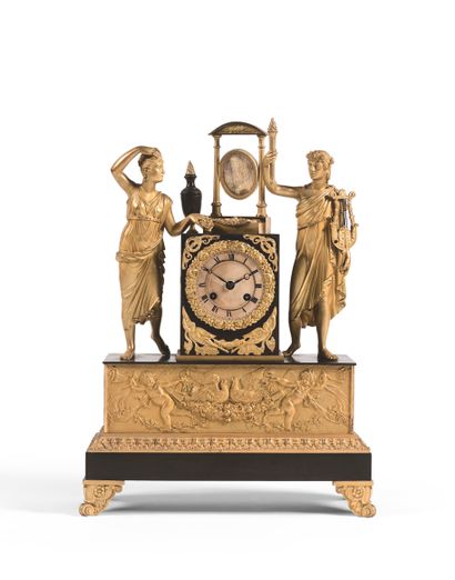 null A bronze clock with a black and gilt patina, the circular dial set in a terminal...