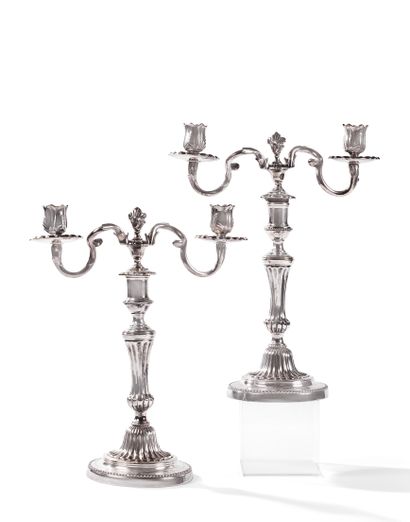 null Pair of silver plated candlesticks, the fluted baluster shaft supporting two...