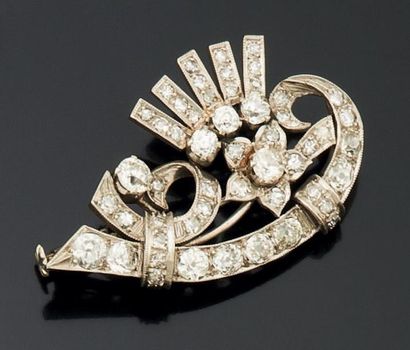 null BROCHE en platine ajouré, à décor de fleur et volutes, entièrement sertie de...