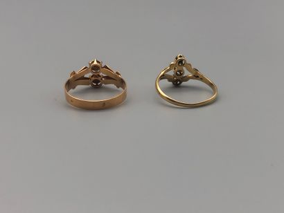 null Two early 20th century gold rings set with half pearls and rose-cut diamonds...