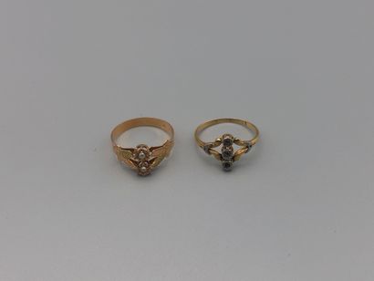 null Two early 20th century gold rings set with half pearls and rose-cut diamonds...
