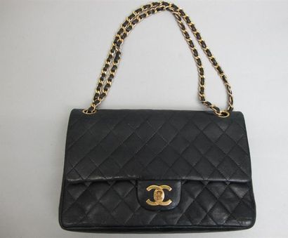 null CHANEL Paris
"Timeless" handbag in black quilted lamb leather with double flaps,...