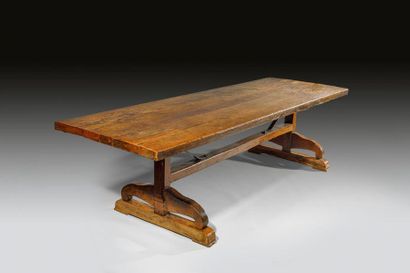 null Oak community table. The table top rests on a console base connected by a spacer....