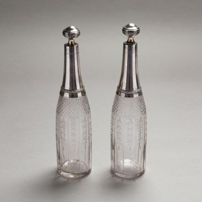 null Pair of glass flasks cut with diamond points and engraved with foliage; silver...