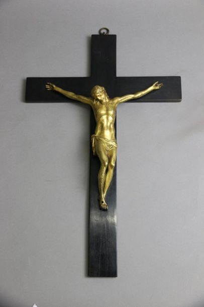 null Christ on cross in chased gilt bronze, cross in blackened wood veneer. 
19th...