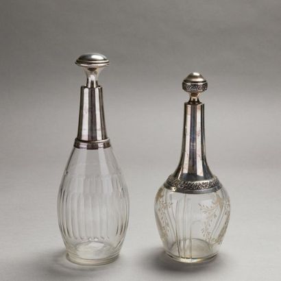 null Two glass bottles with silver Minerva hallmark mounting; one with engraved flower...