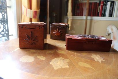 null Three puzzle boxes with lizard decoration in exotic wood.
