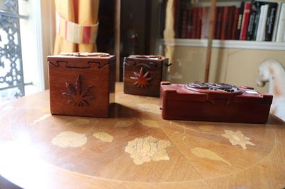 null Three puzzle boxes with lizard decoration in exotic wood.

