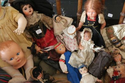 null Set of celluloid porcelain dolls and a plastic rocking horse.
