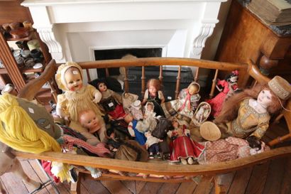 null Set of celluloid porcelain dolls and a plastic rocking horse.
