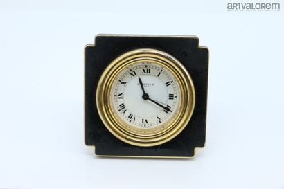 null CARTIER Paris 

Gold brass and black enamel travel alarm clock. Square case...